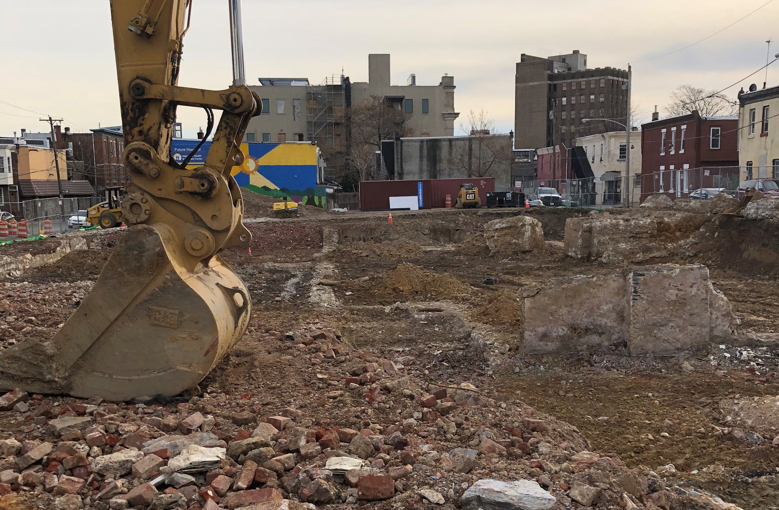 An excavator lies still at the site of Esperanza Health Center’s forthcoming parking structure.